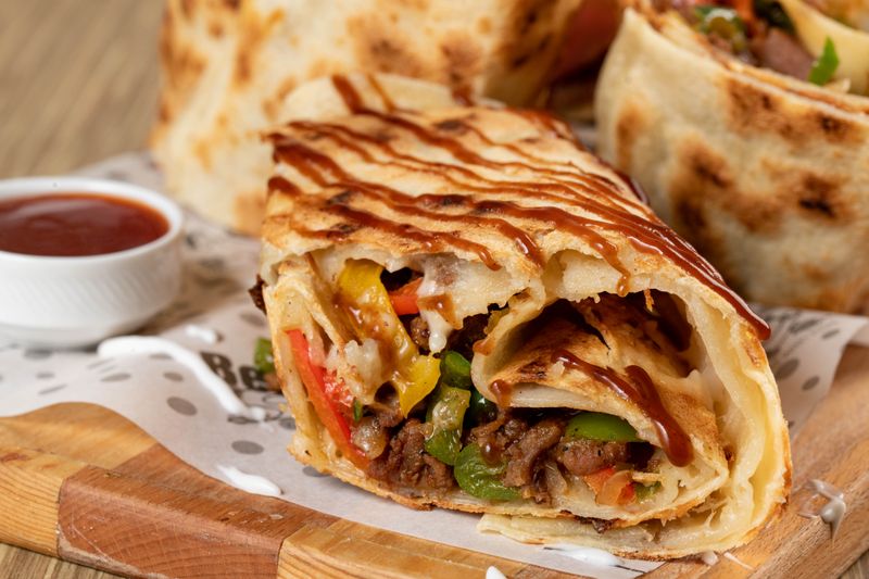 Cafe Rio pork carnitas burrito smothered in enchilada sauce